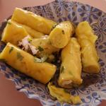 These khandvi rolls are a  Gujarati specialty. A cooked batter of chickpea flour and buttermilk is spread thin and cooled, then rolled with coconut and spices for a savory snack.