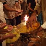 Devotees eagerly come to   take prasad of fruit and sugar pellets after the nightly worship of the river goddess Ganga, at Dashashwamedha Ghat in Banares.