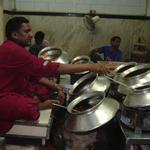 Also near the great mosque, Delhi's famous old Karim's restaurant offers mughalai specialties, rich meat kormas, pasandas, kababs and biryanis. This cook tends the various pots of simmering curries and dals.