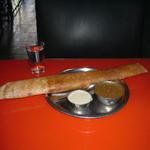 A "rocket dosa" is a paper-thin crispy crepe, rolled around a spicy potato filling, and served with the traditional South Indian accompaniments, sambar and coconut chutney.